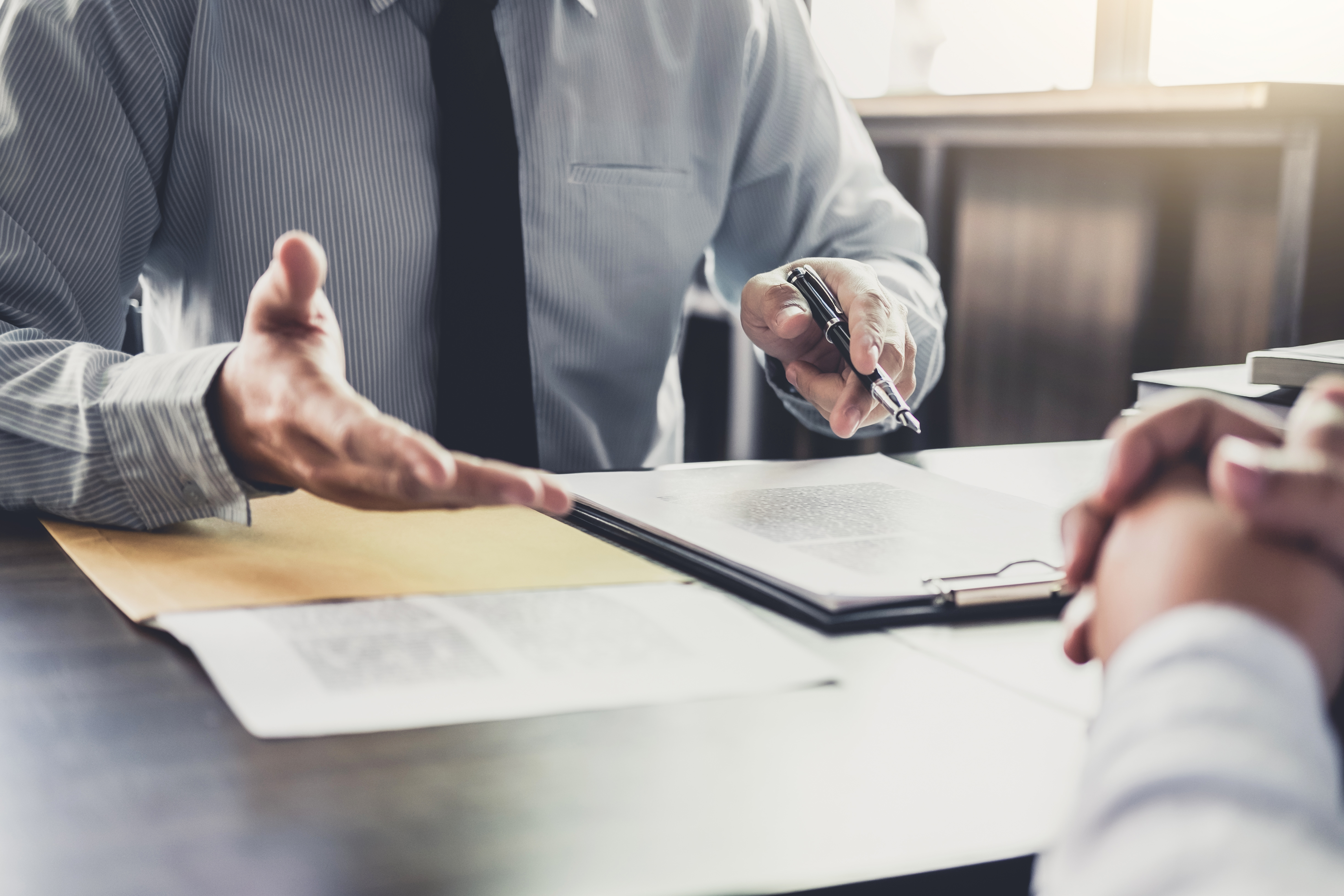 Business consultant discussing documents and technology plans